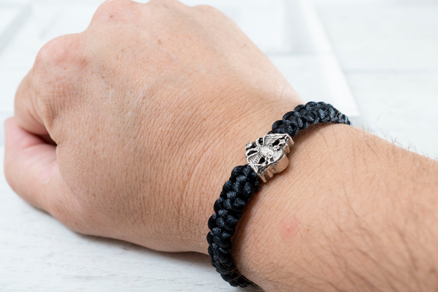 Antique silver tone Orthodox crest adjustable cord bracelet displayed on a clean background