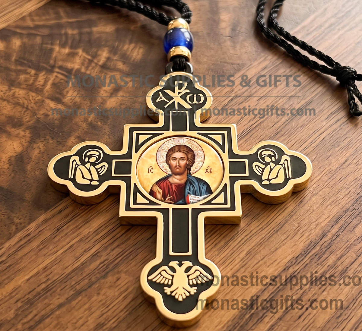 Byzantine double-sided hanging cross protection amulet with gold and black accents, featuring an Orthodox icon of Virgin Mary on one side and Jesus Christ on the reverse, Chi-Rho symbol at the top, praying angels, and a double-headed eagle on a wooden surface.