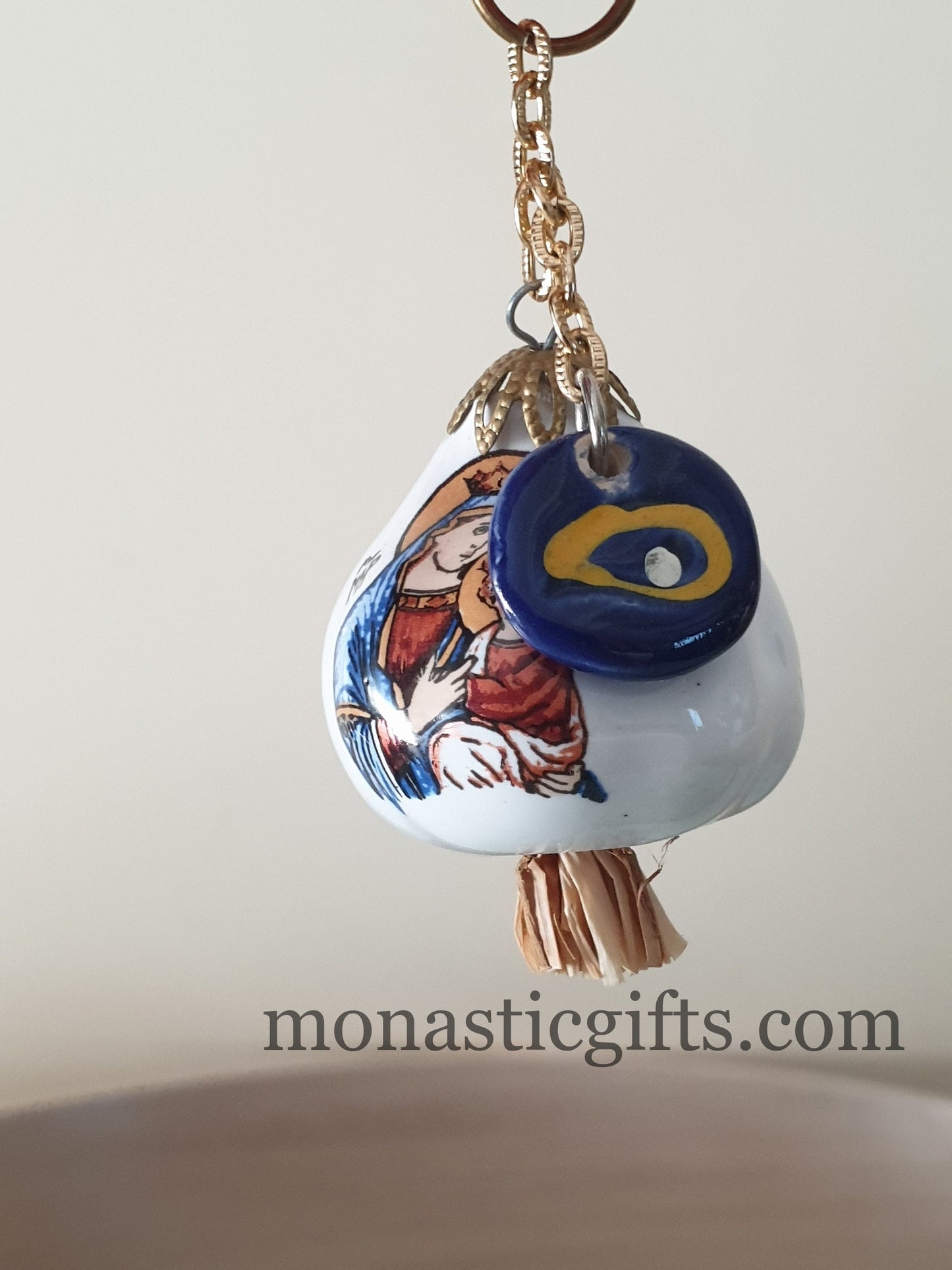 Garlic charm with the Virgin Mary on one side and the Christian Cross on the back and glass evil eye.Lucky charm.