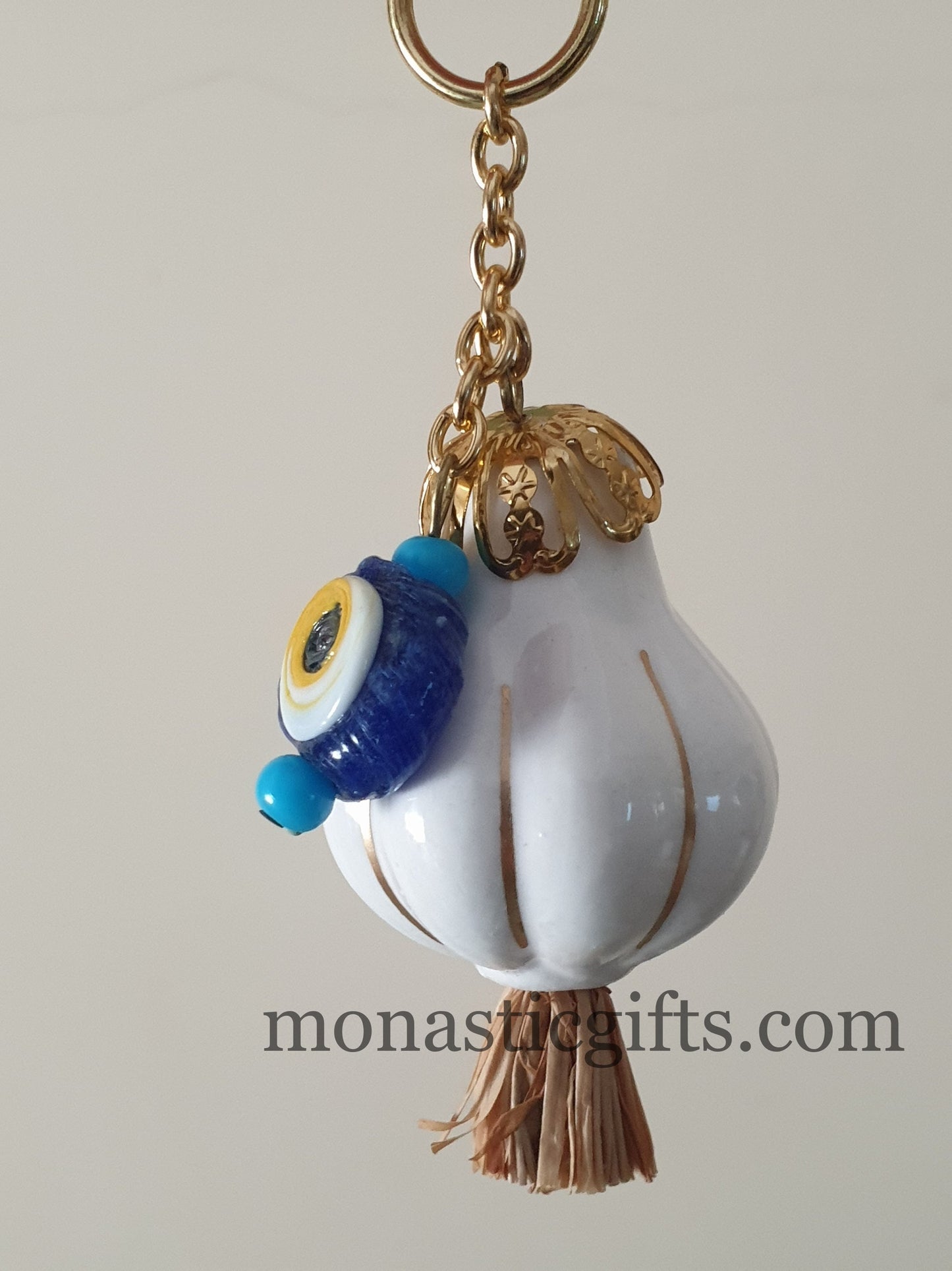 Garlic charm with the Virgin Mary on one side and the Christian Cross on the back and glass evil eye.Lucky charm.
