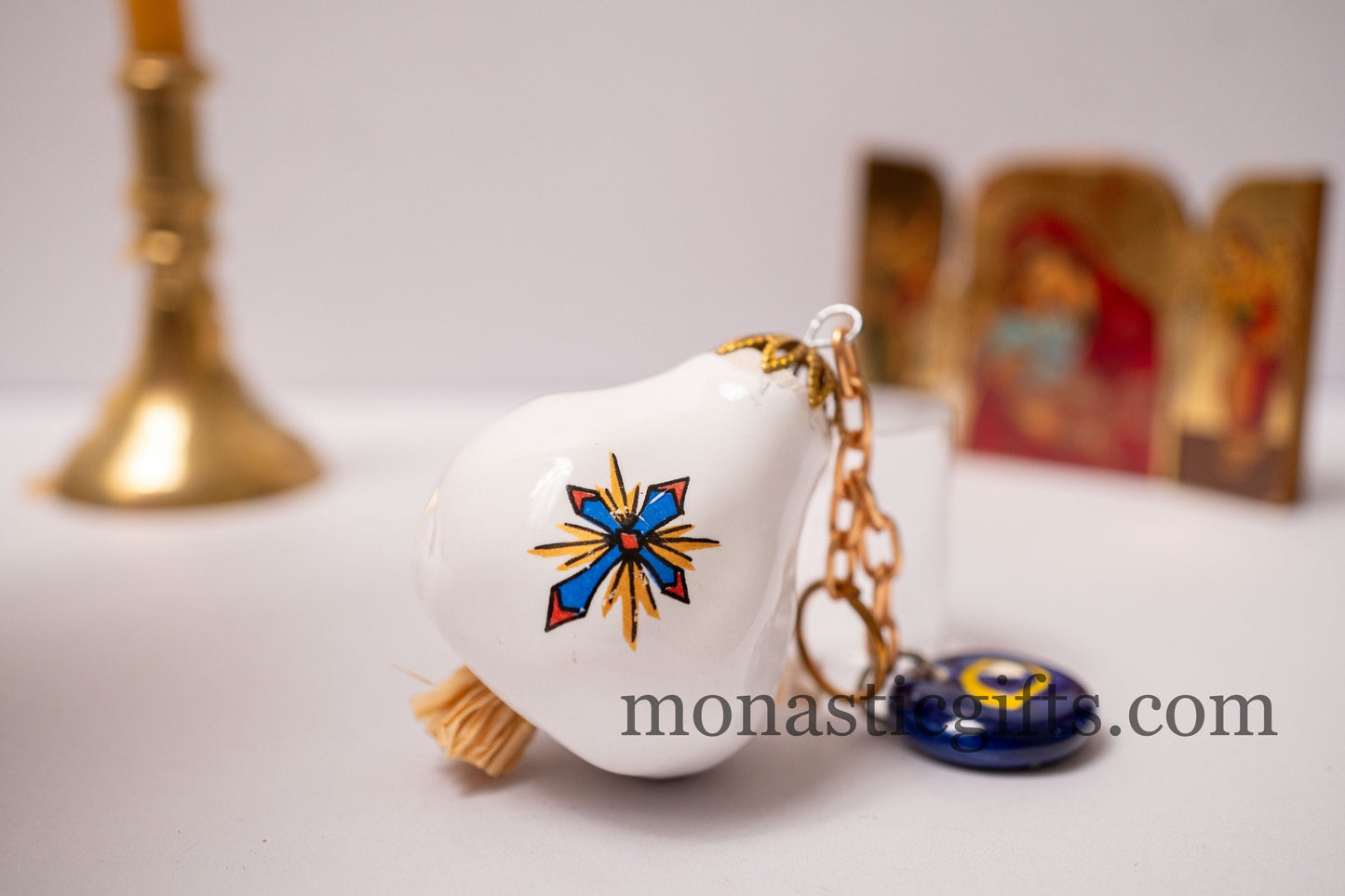 Garlic charm with the Virgin Mary on one side and the Christian Cross on the back and glass evil eye.Lucky charm.
