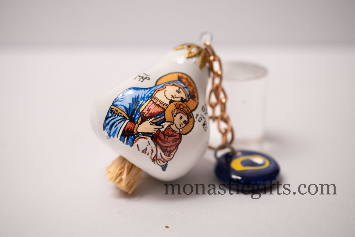Garlic charm with the Virgin Mary on one side and the Christian Cross on the back and glass evil eye.Lucky charm.
