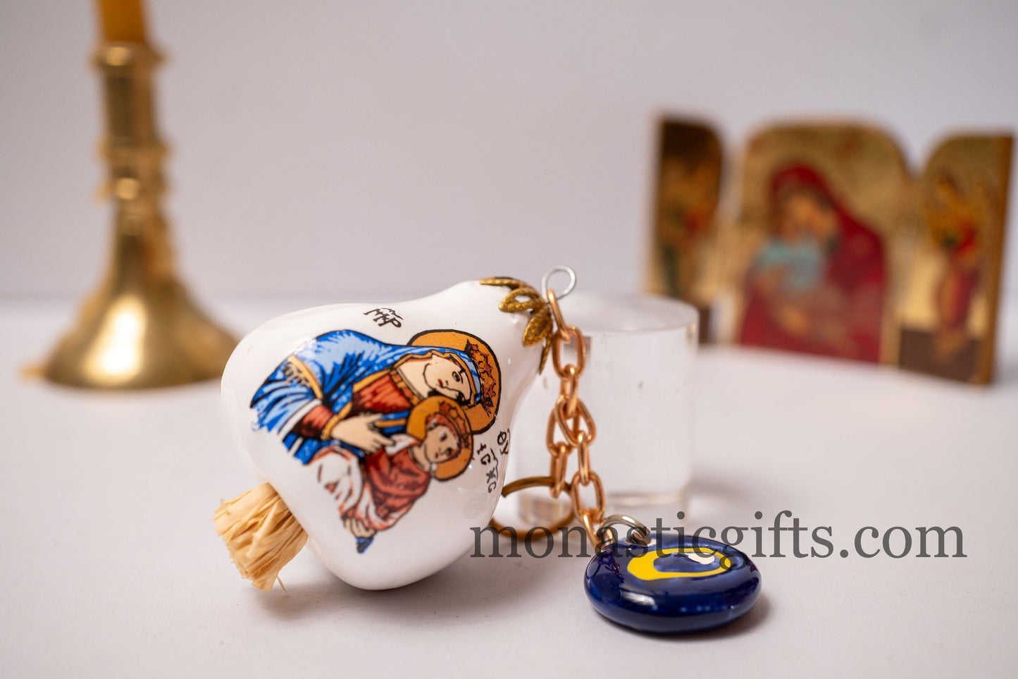 Garlic charm with the Virgin Mary on one side and the Christian Cross on the back and glass evil eye.Lucky charm.