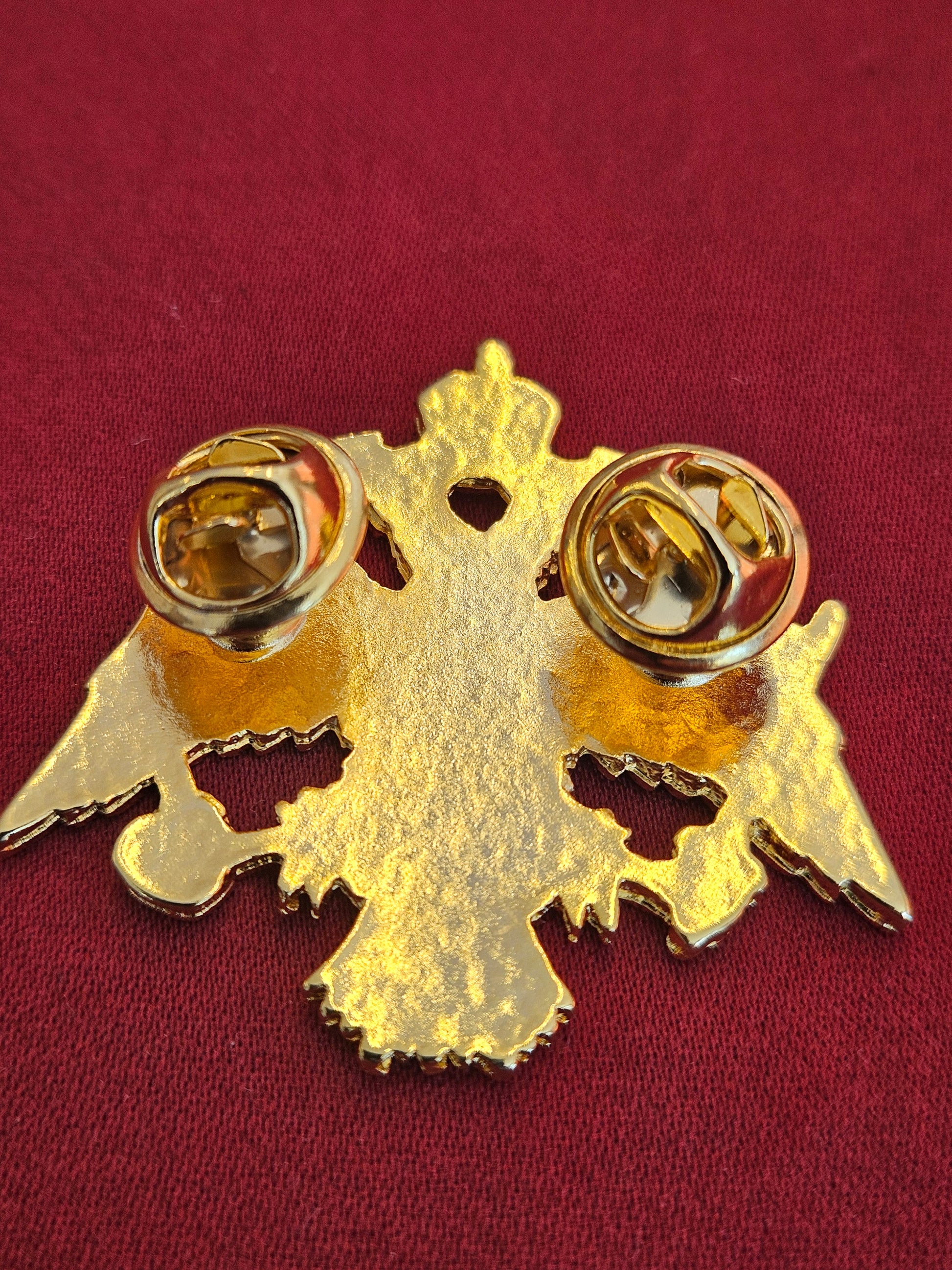 Back view of the large gold Byzantine eagle brooch showing the secure double butterfly clutch pins