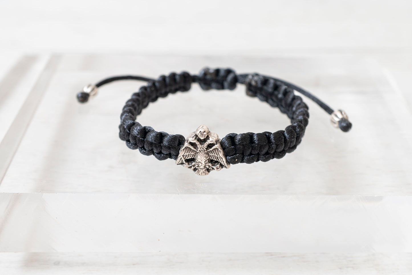 Antique silver tone Orthodox crest adjustable cord bracelet displayed on a clean background