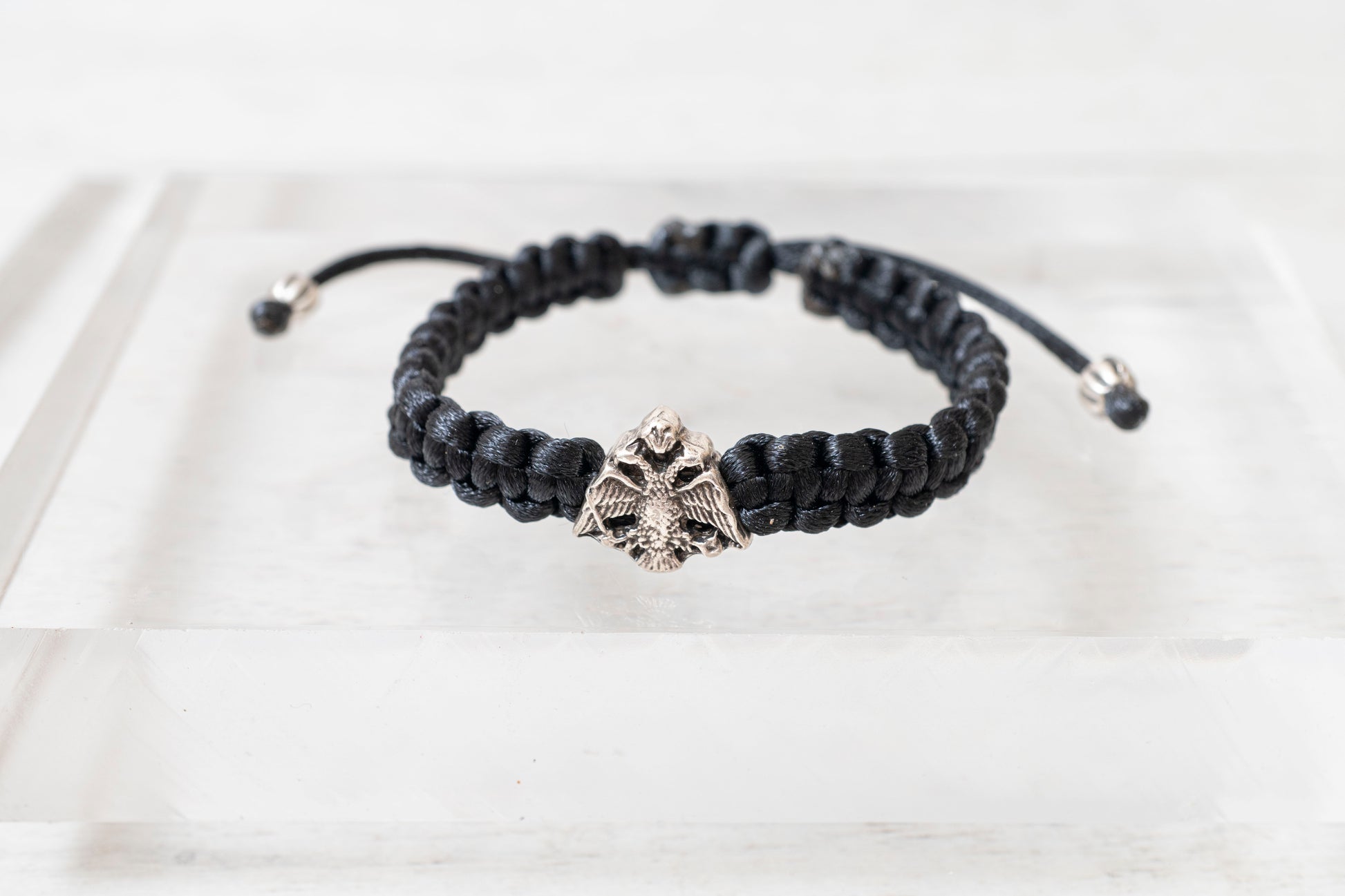 Antique silver tone Orthodox crest adjustable cord bracelet displayed on a clean background