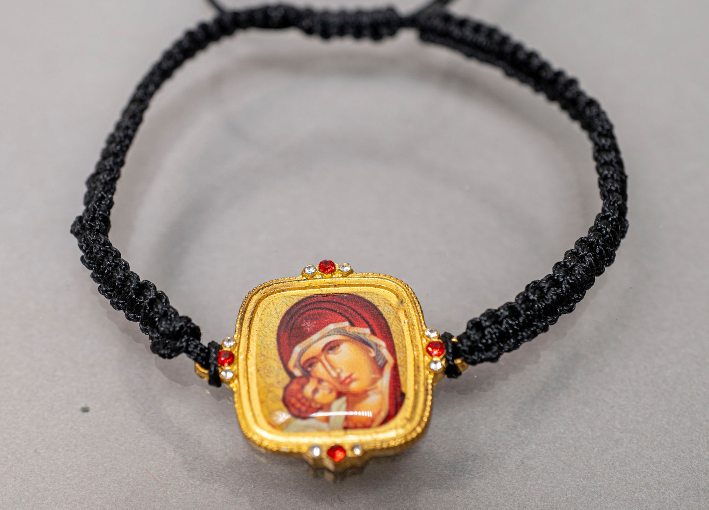 Adjustable knotted black cord bracelet with Virgin Mary icon and crystal accents gold tone made in Greece