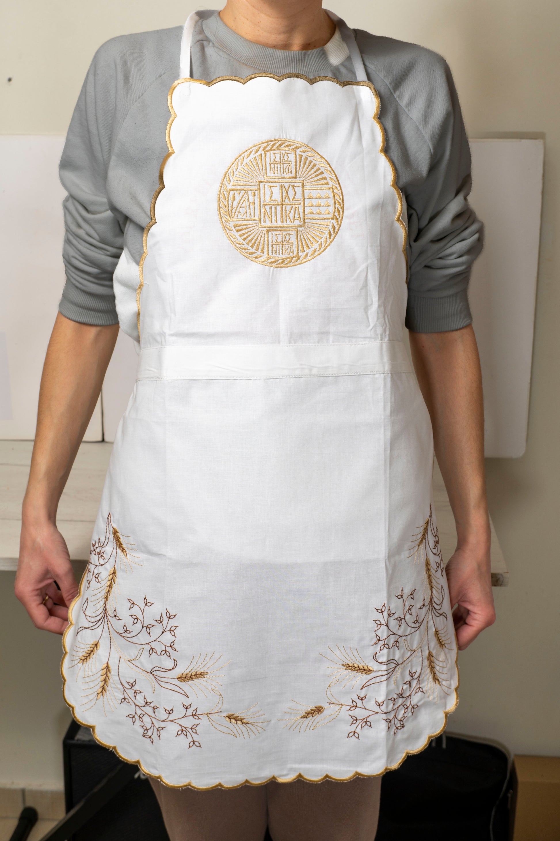 Handcrafted white cotton kitchen apron with gold embroidered prosphoron seal and wheat sheaves made in Greece