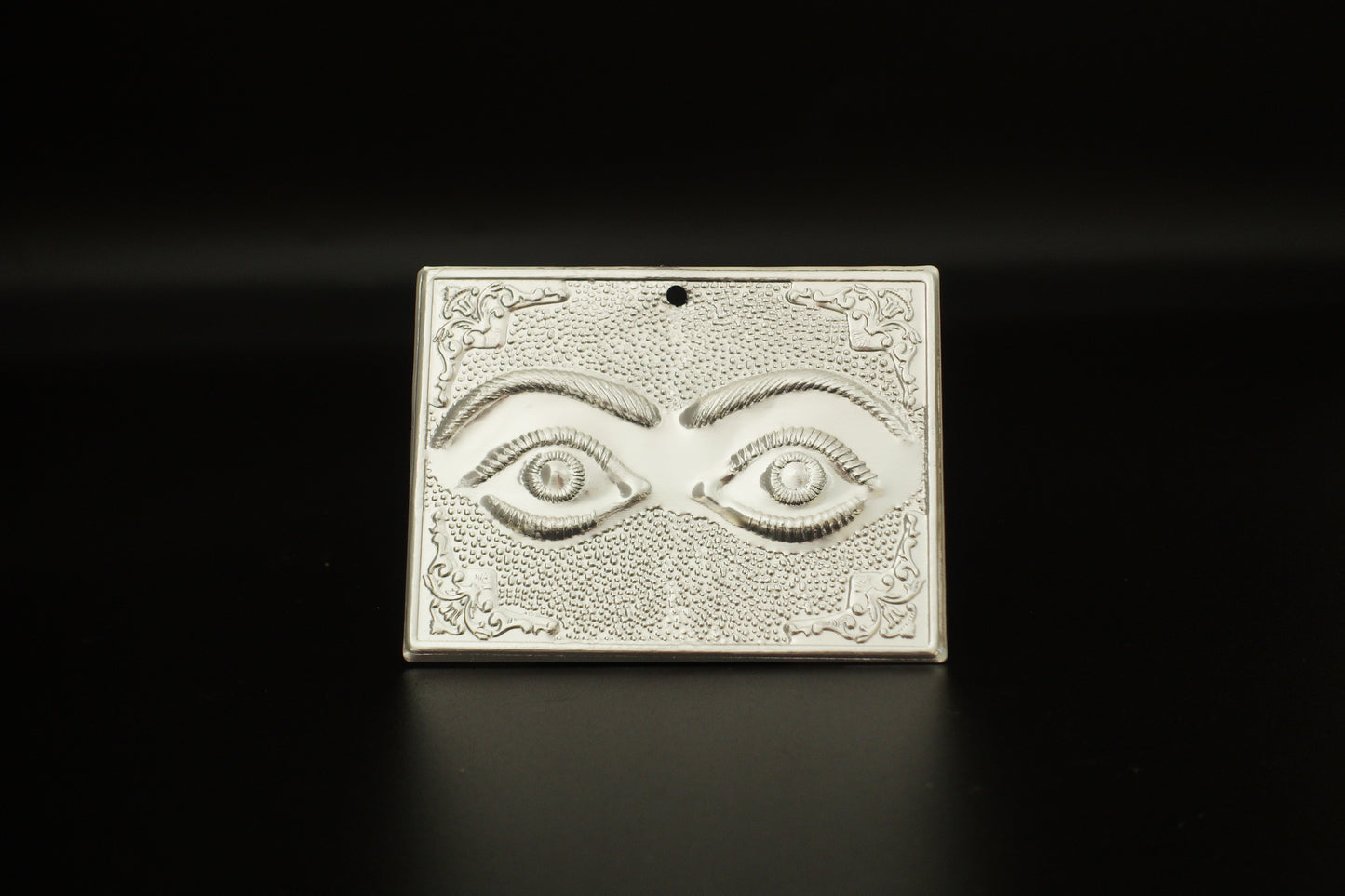 Plain silver-tone Greek Orthodox tama votive offering plaque embossed with a pair of eyes motif and a small pre-drilled top hole for hanging.