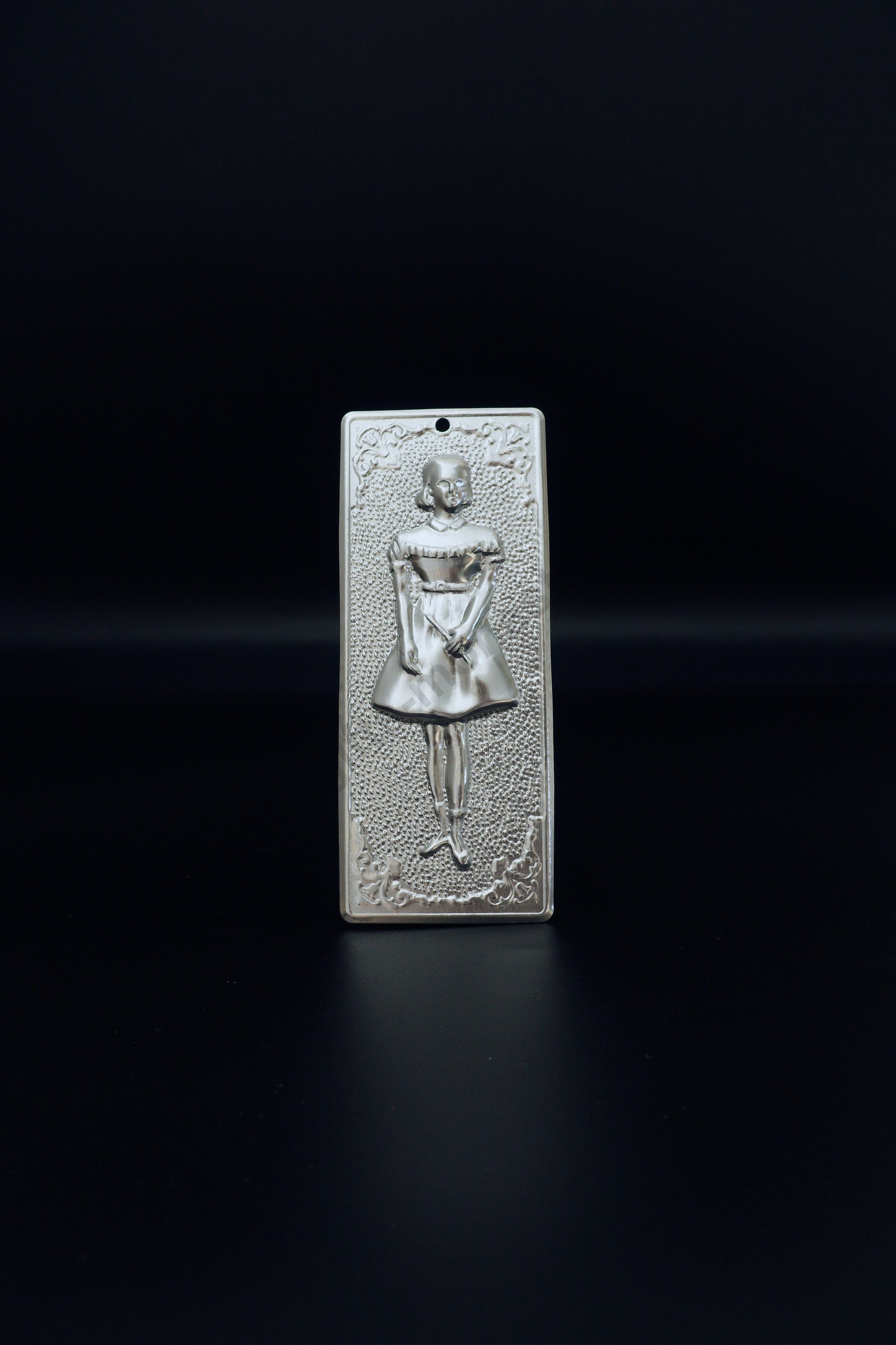 Plain silver-tone Greek Orthodox tama votive offering plaque embossed with a young girl figure and a small pre-drilled top hole for hanging.