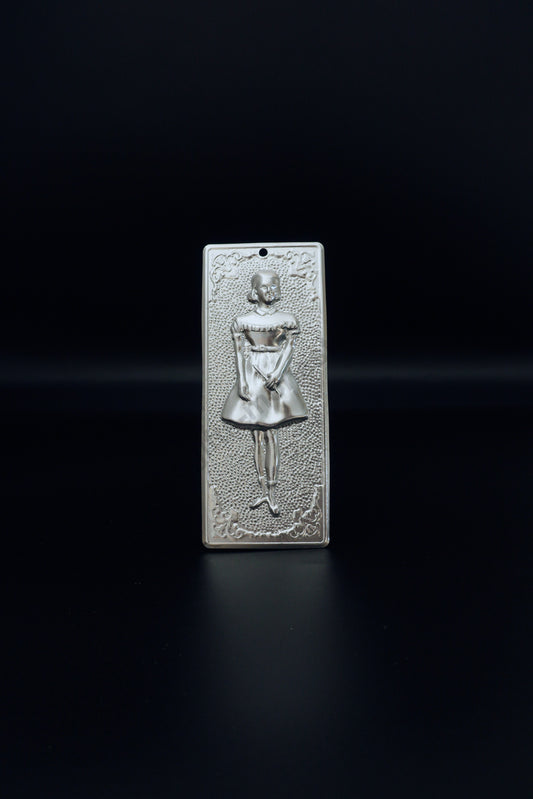 Plain silver-tone Greek Orthodox tama votive offering plaque embossed with a young girl figure and a small pre-drilled top hole for hanging.