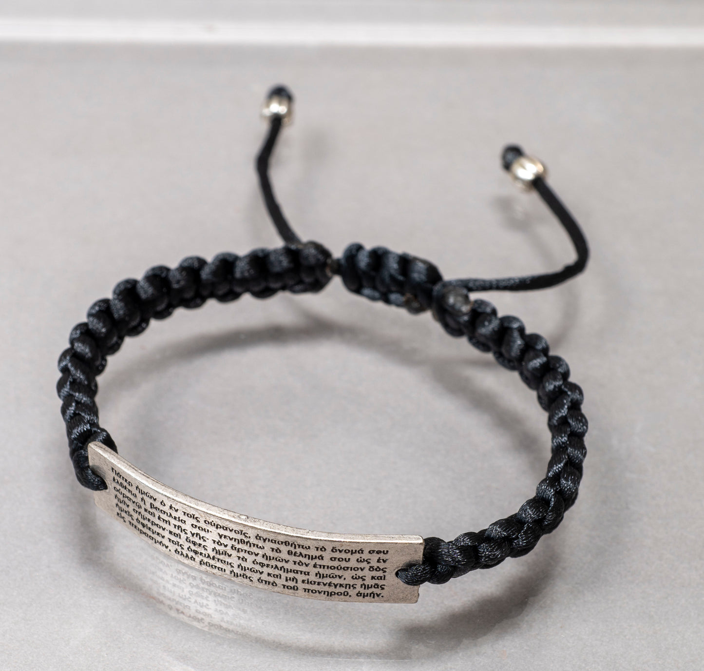Handcrafted black cord adjustable macrame bracelet with silver Pater Noster prayer plate