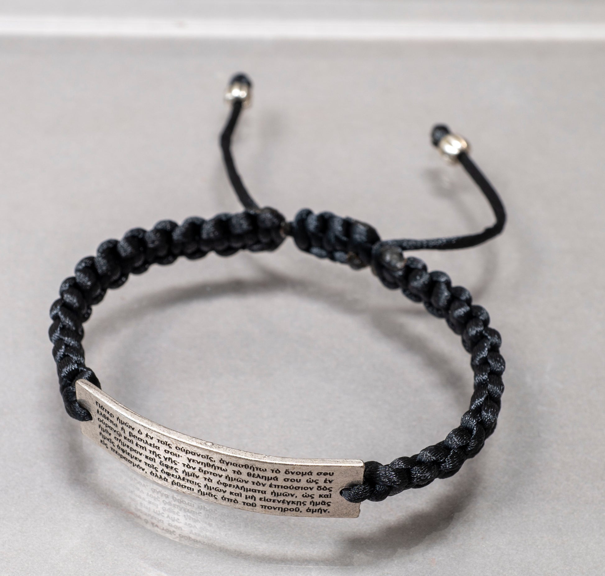 Handcrafted black cord adjustable macrame bracelet with silver Pater Noster prayer plate