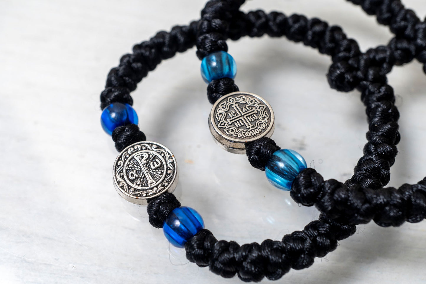 Elastic Prayer Rope Komboskini Bracelet with Chi-Rho Medallion and Blue Beads - 33 Knots - 1 Piece - Black Cord