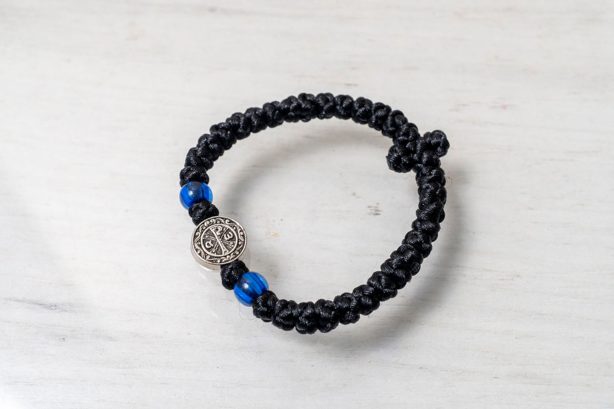 Elastic Prayer Rope Komboskini Bracelet with Chi-Rho Medallion and Blue Beads - 33 Knots - 1 Piece - Black Cord