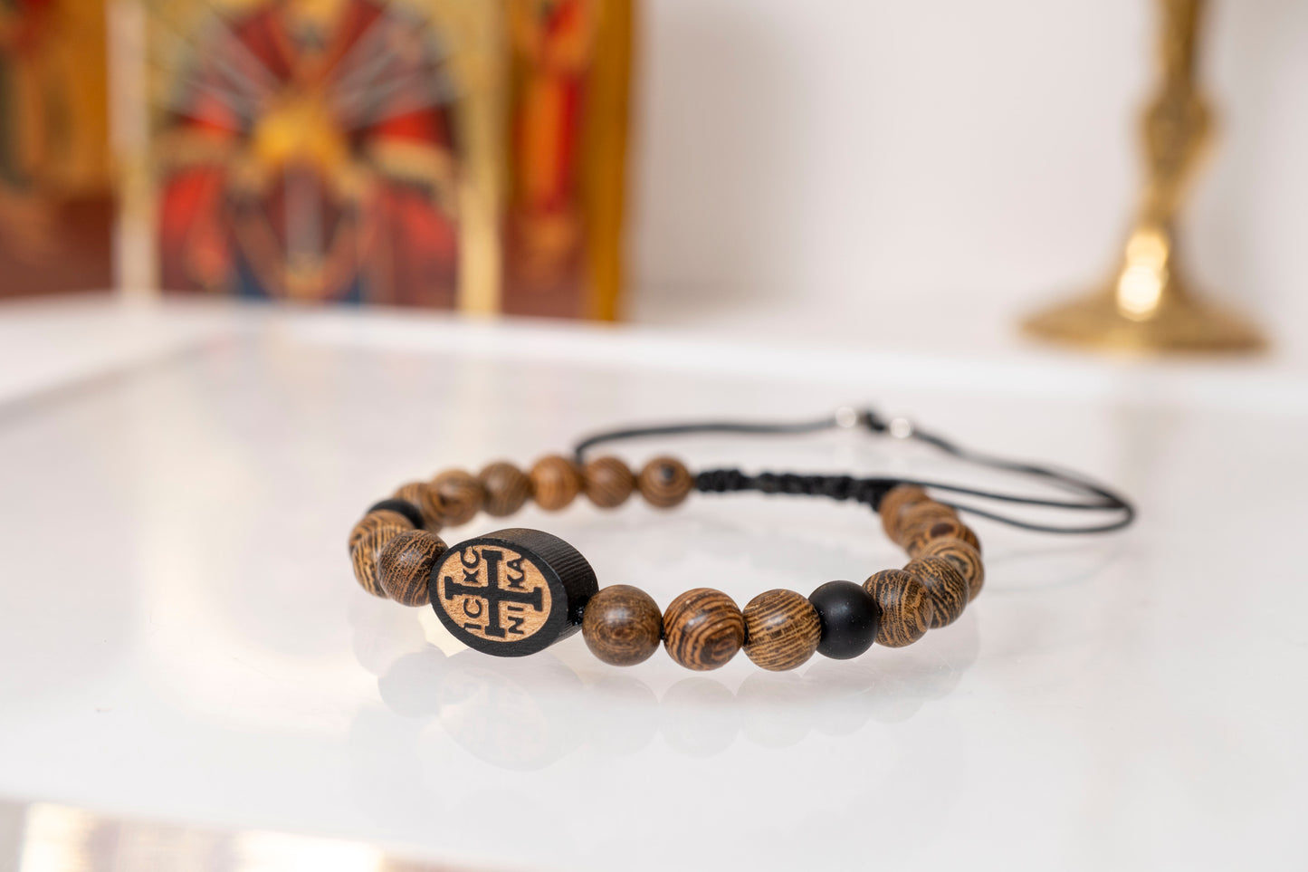 Handcrafted Christian bracelet made of natural grained brown wooden beads with an engraved IC XC NIKA cross centerpiece