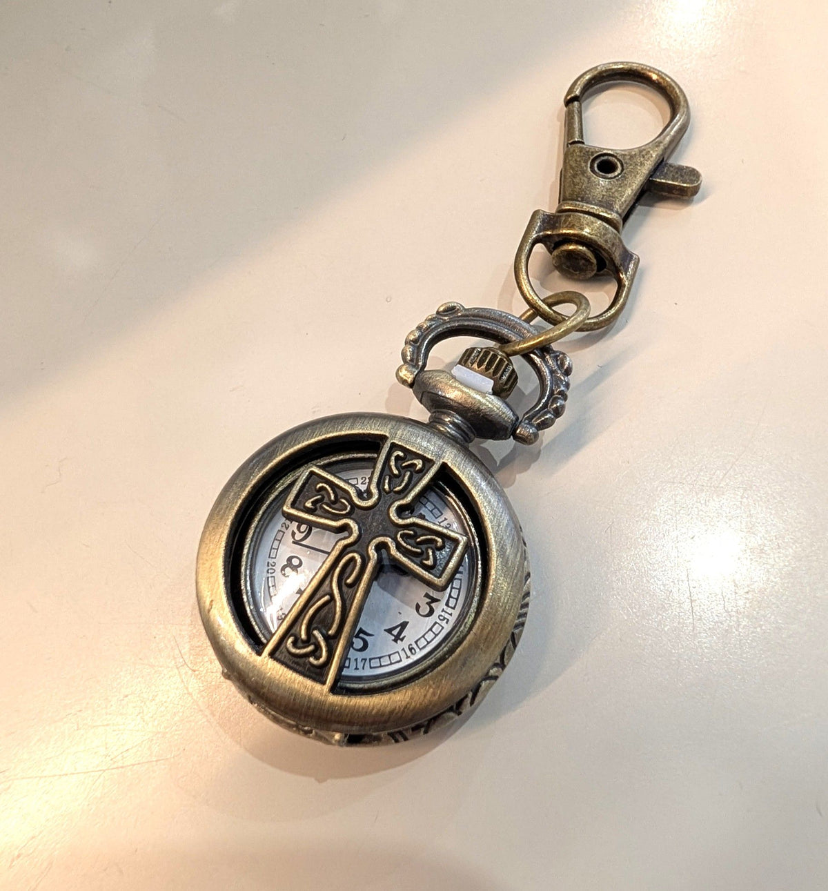 Mini pocket watch keychain antique bronze with cutout cross front and swivel bag clip