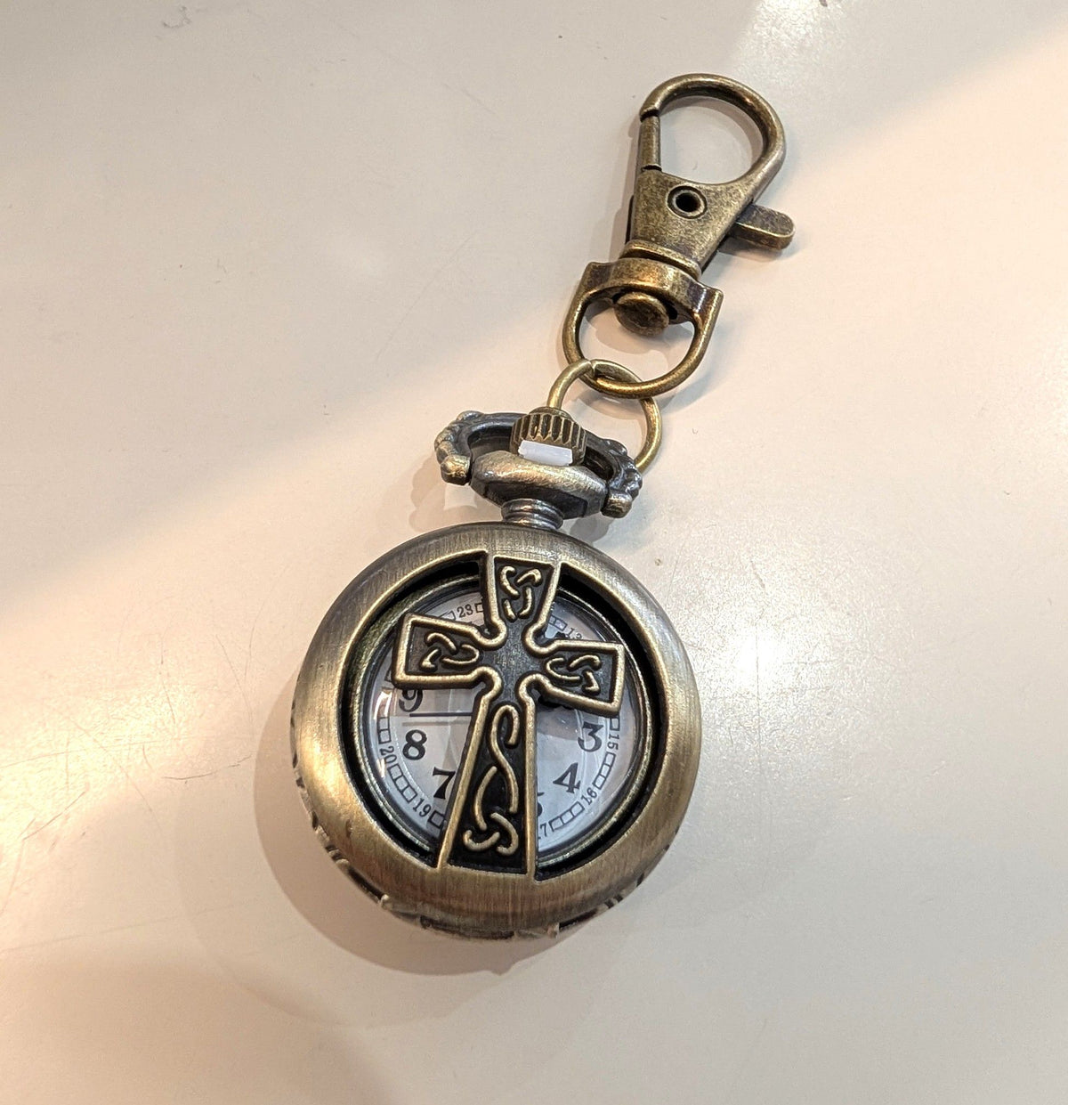 Mini pocket watch keychain antique bronze with cutout cross front and swivel bag clip