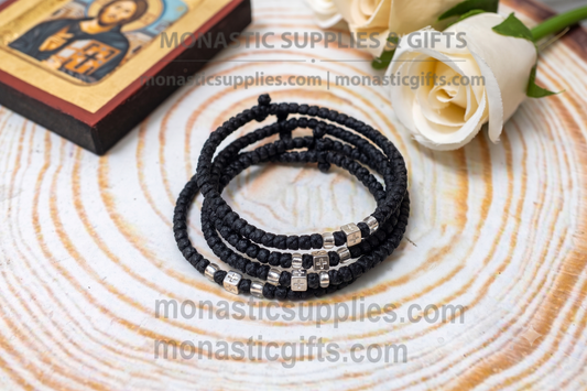 Handcrafted black waxed Orthodox prayer rope komboskini bracelet with thin knots, silver beads, and all-sided cross metal element.
