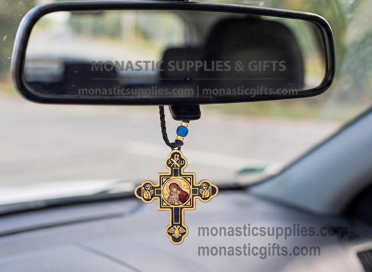Byzantine double-sided hanging cross protection amulet with gold and black accents, featuring an Orthodox icon of Virgin Mary on one side and Jesus Christ on the reverse, Chi-Rho symbol at the top, praying angels, and a double-headed eagle on a wooden surface.