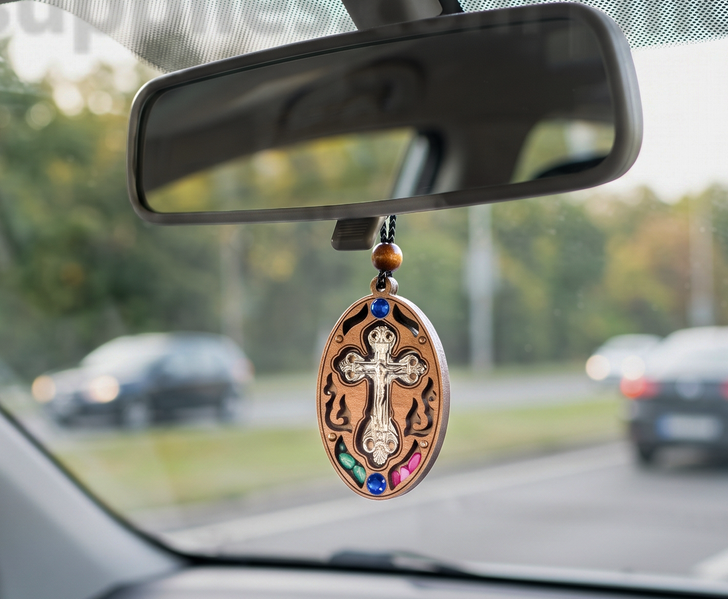 Handcrafted wooden oval cross protection amulet and car mirror charm with intricate carved cutout filigree, 