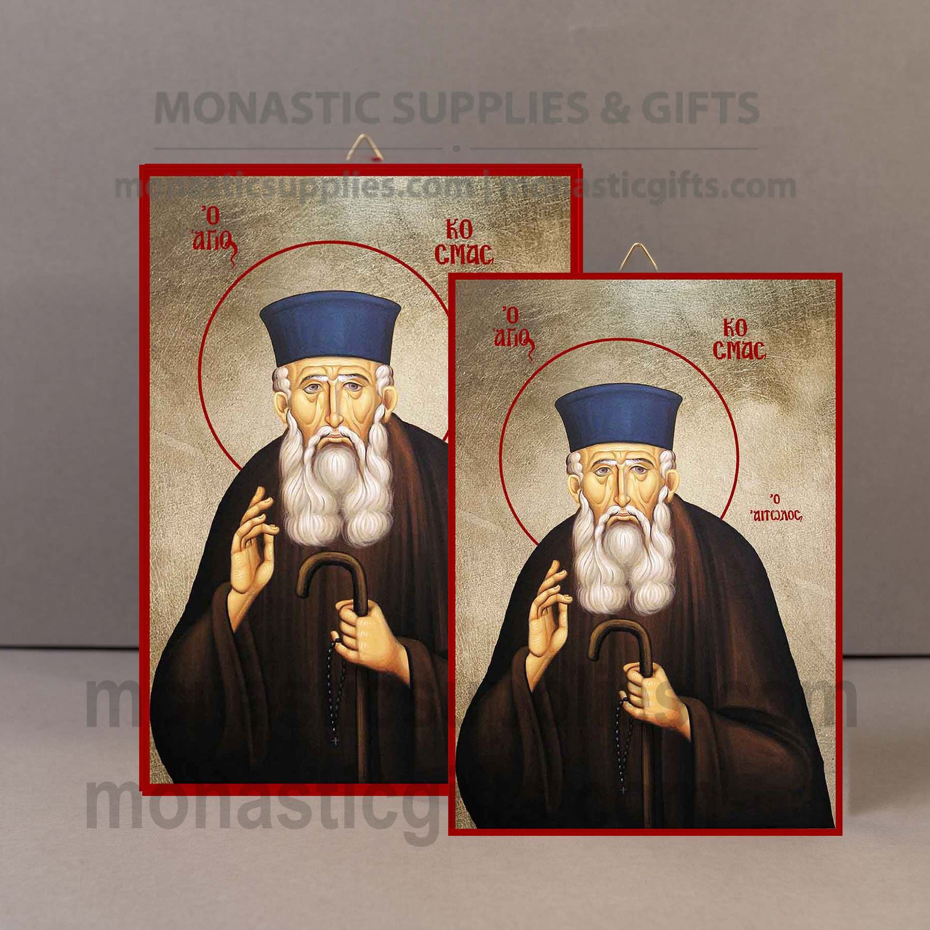 Two rectangular religious icon prints showing a bearded saint in a blue hat and dark robe, with red borders and gold-toned background, displayed against a plain gray backdrop. A faint Monastic Supplies & Gifts watermark is visible across the image.