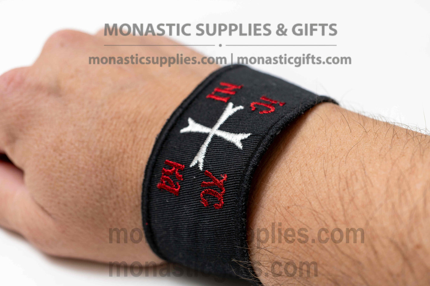 Handcrafted black fabric Orthodox wristband with embroidered white Byzantine cross and red IC XC NIKA inscription made in Greece