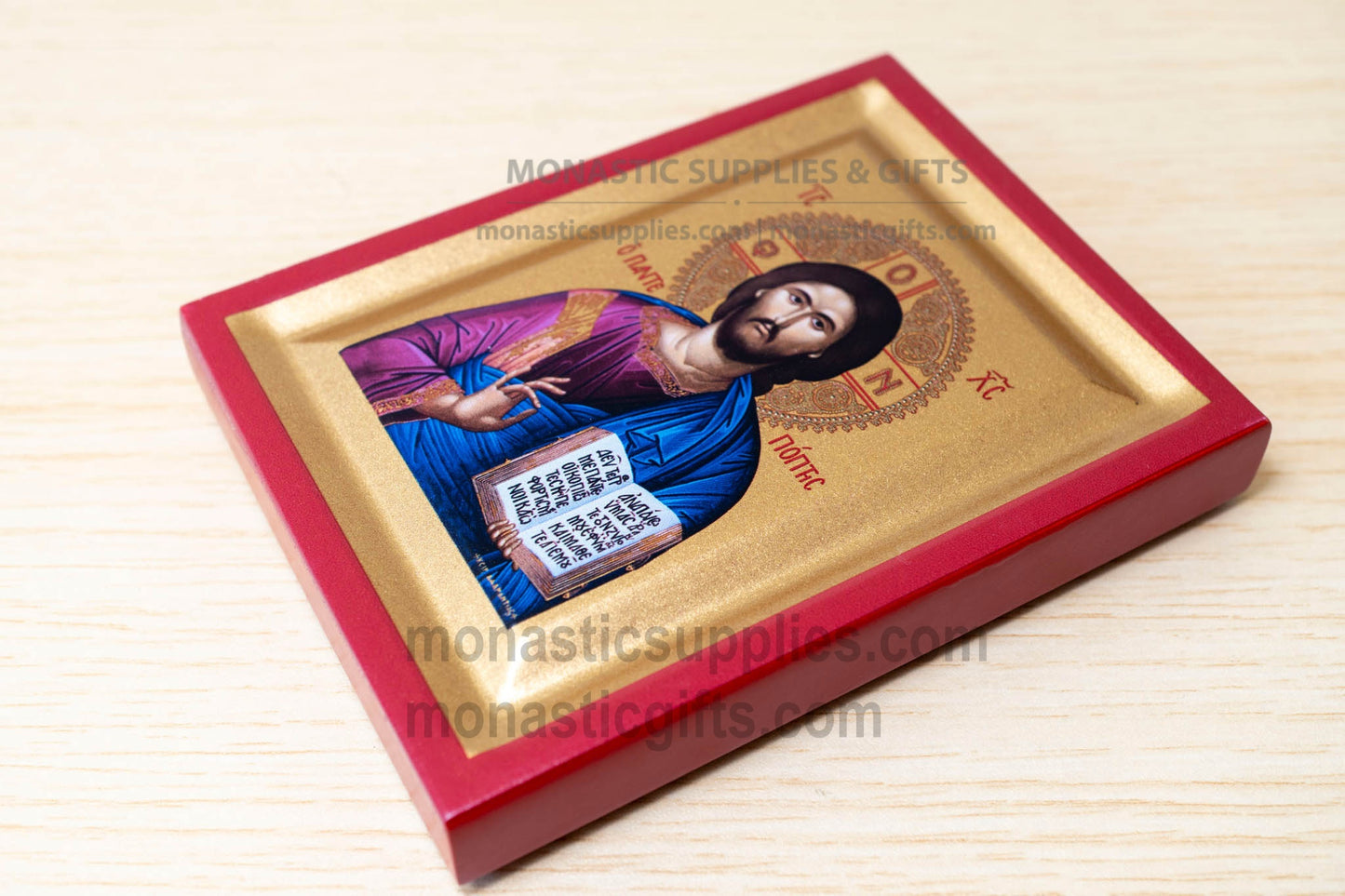 Icon of a religious figure in a red and gold frame on a beige background