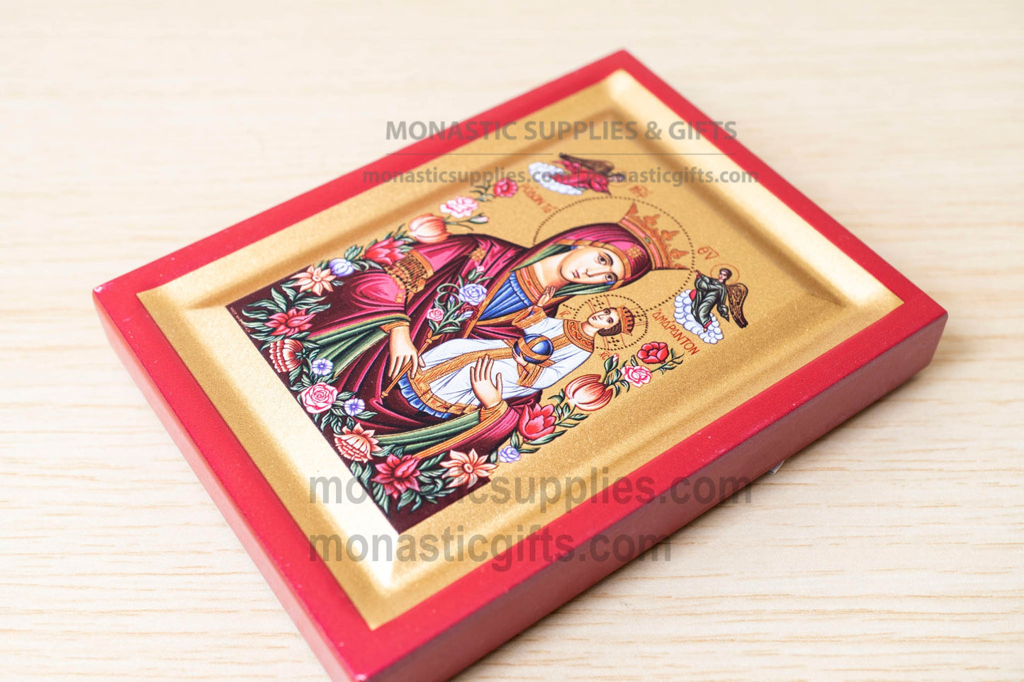 Decorative icon with a red border on a wooden surface