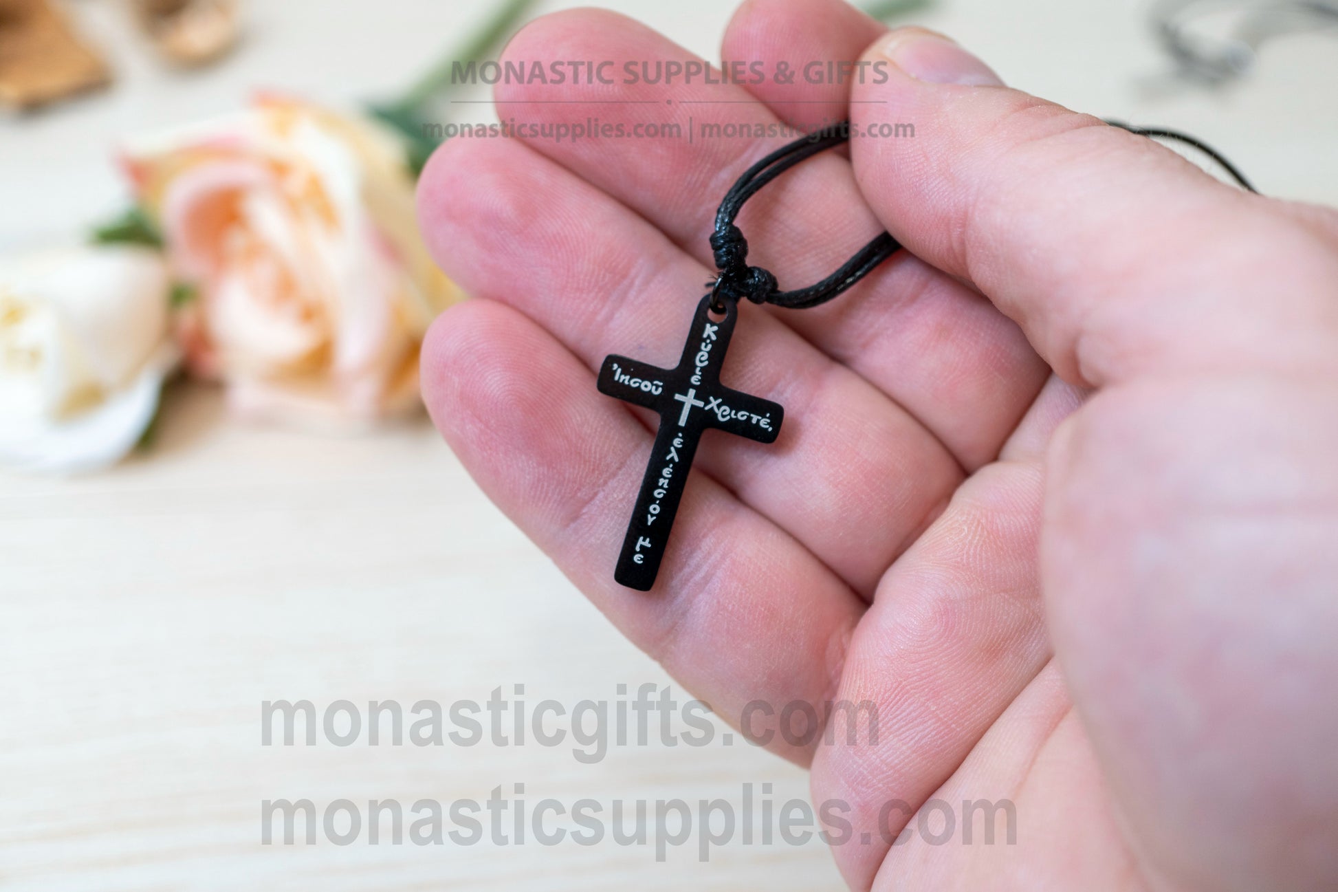 Orthodox black metallic cross necklace engraved with the Jesus Prayer in Greek.