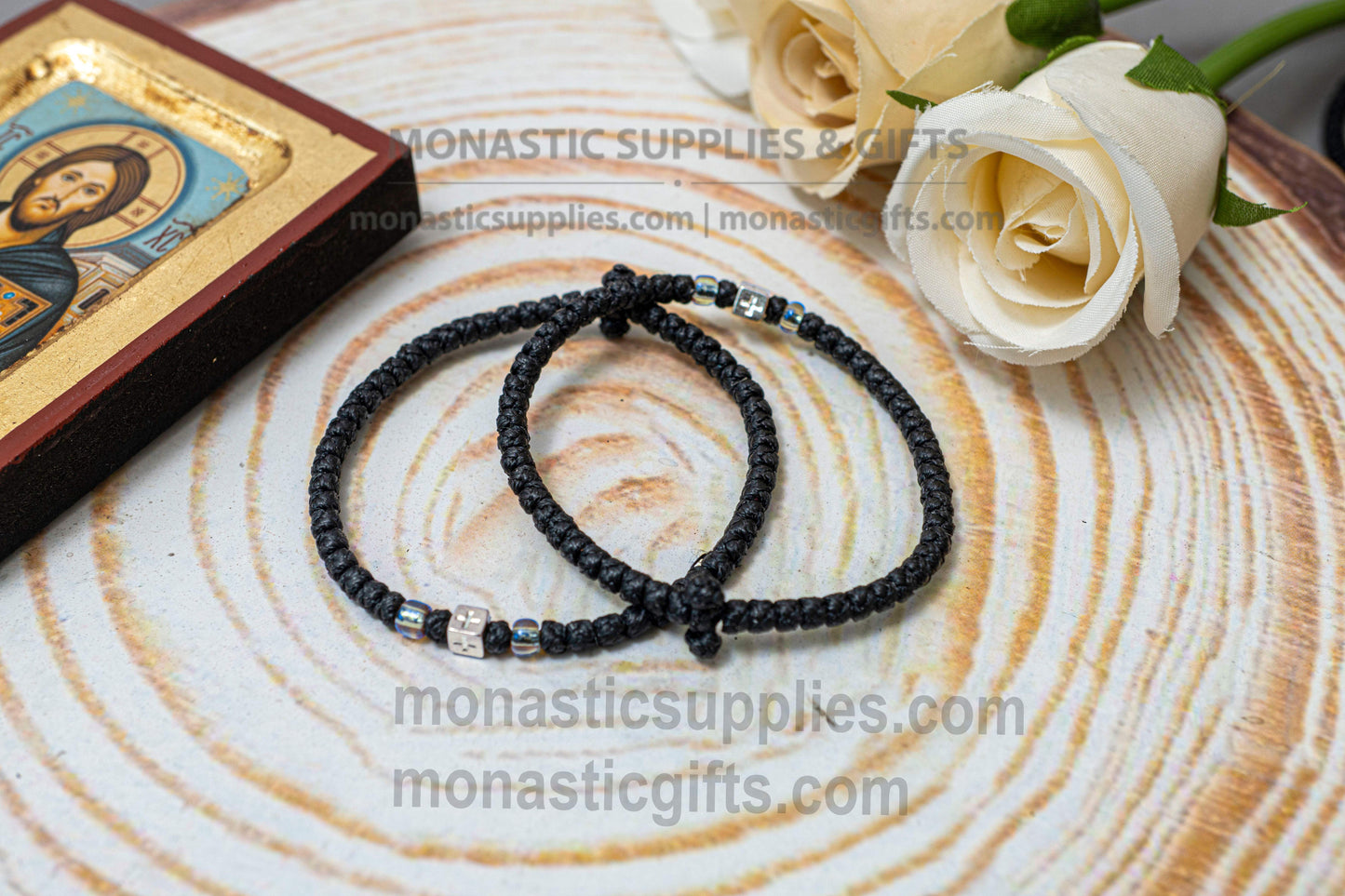 Handcrafted black waxed Orthodox prayer rope komboskini bracelet with thin knots, silver beads, and all-sided cross metal element.