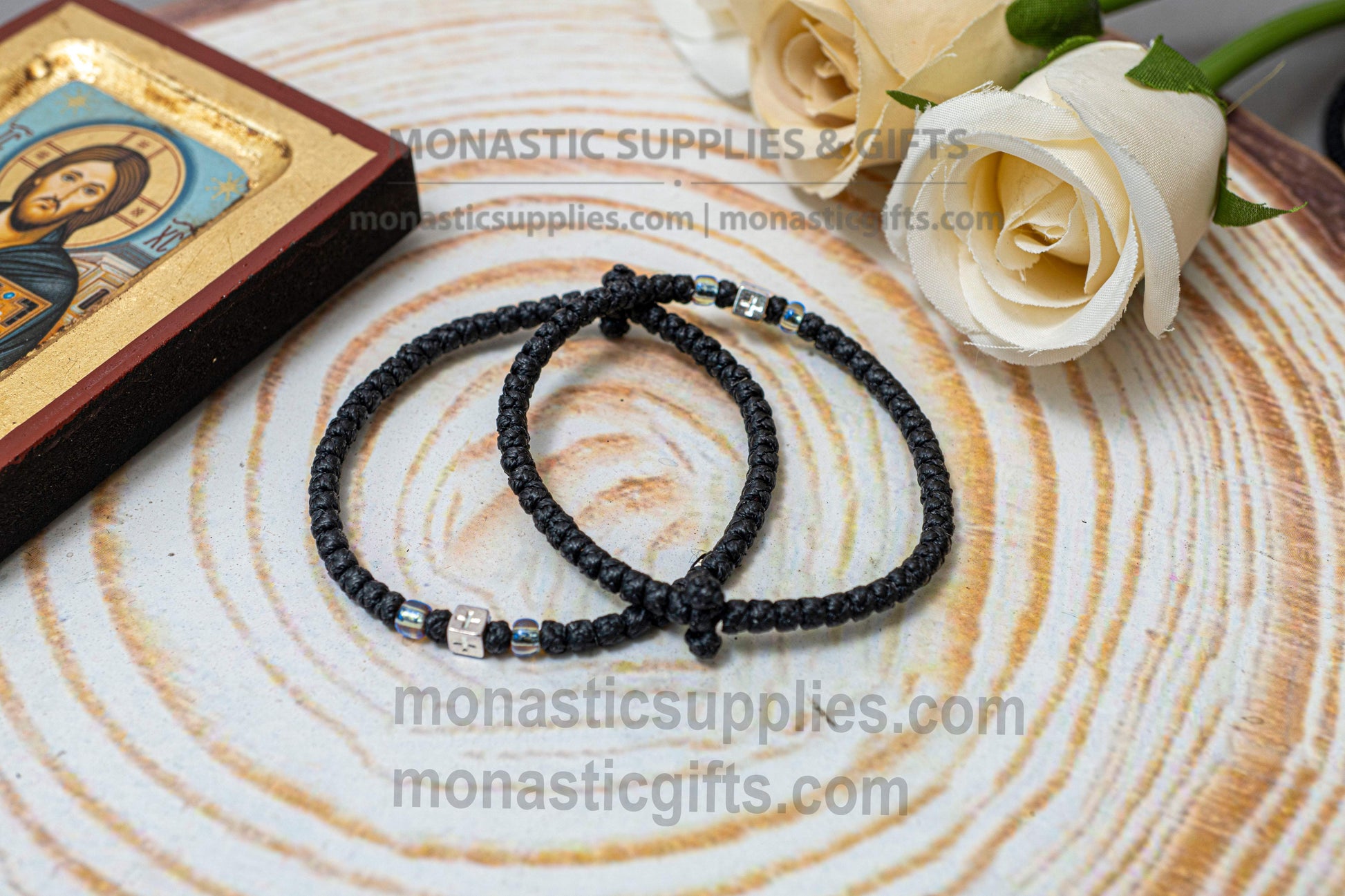 Handcrafted black waxed Orthodox prayer rope komboskini bracelet with thin knots, silver beads, and all-sided cross metal element.