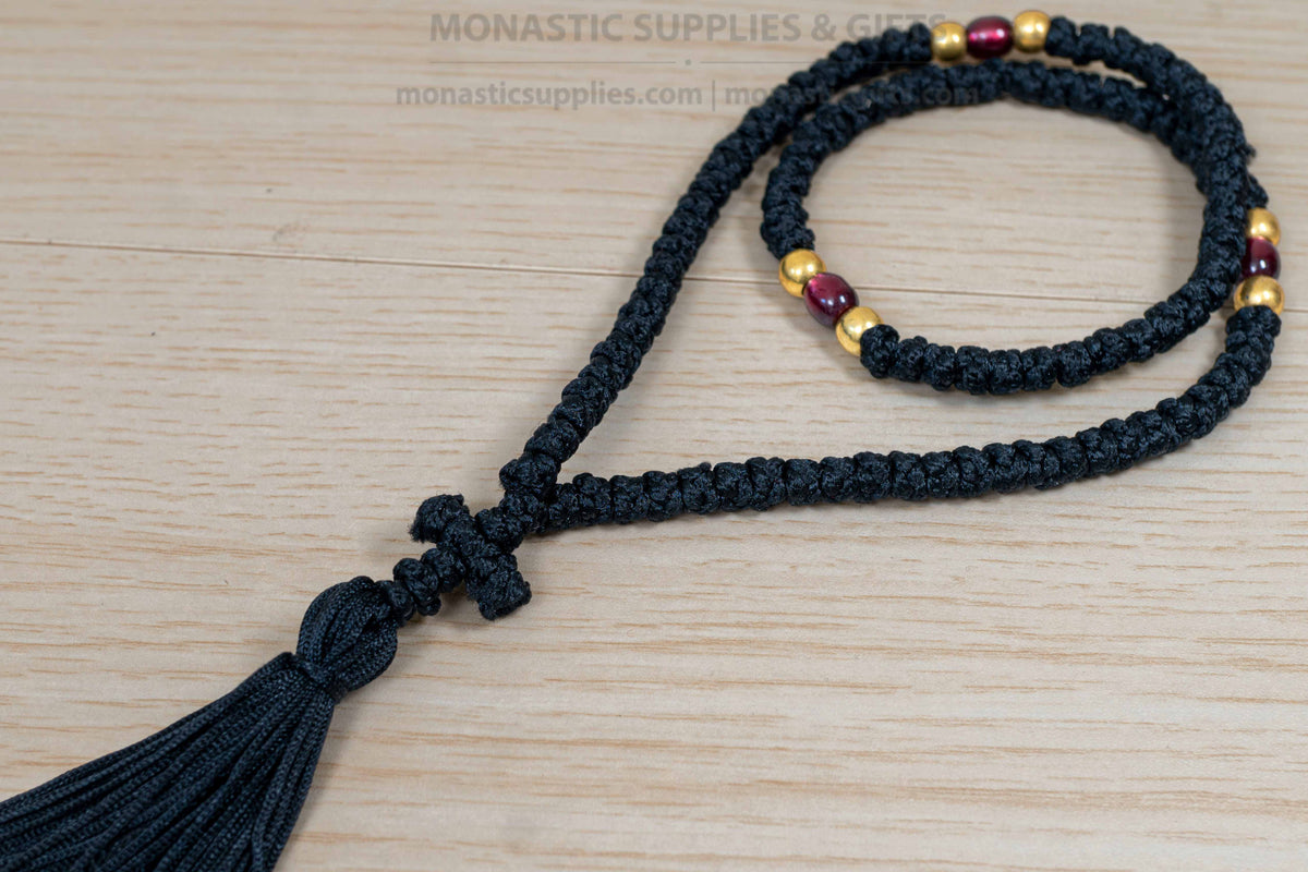 Monastic Orthodox prayer rope 100 knots with tassel knotted cross gold and translucent red beads in black cord made in Greece