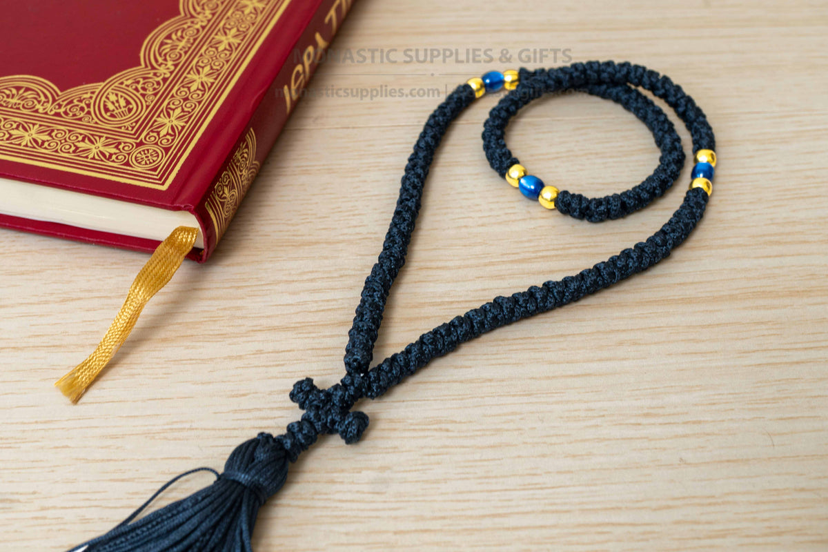 Monastic Orthodox prayer rope 100 knots with tassel knotted cross gold and translucent blue beads in black cord made in Greece
