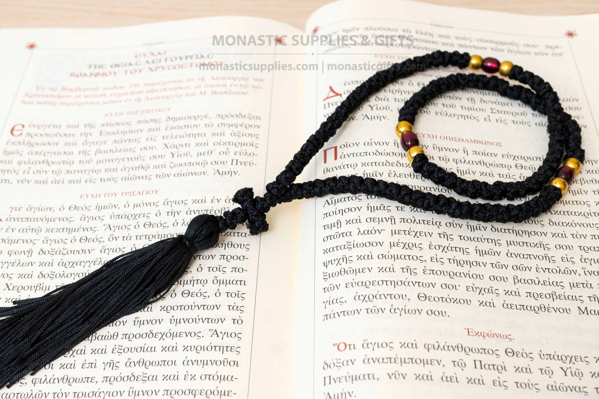 Monastic Orthodox prayer rope 100 knots with tassel knotted cross gold and translucent red beads in black cord made in Greece