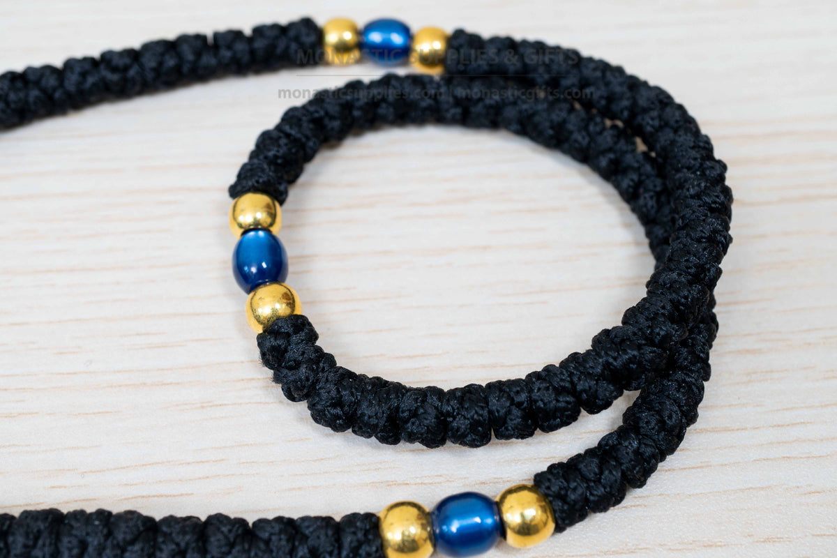Monastic Orthodox prayer rope 100 knots with tassel knotted cross gold and translucent blue beads in black cord made in Greece