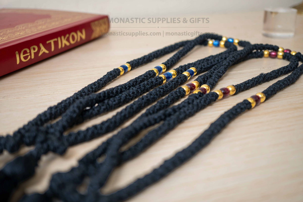 Monastic Orthodox prayer rope 100 knots with tassel knotted cross gold and translucent blue beads in black cord made in Greece