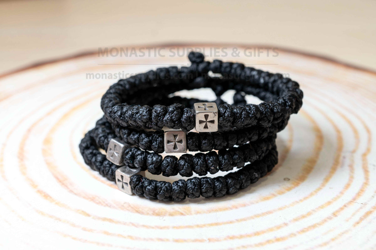 Thick black komboskini wristband with 33 knots and antique silver cross bead made in Greece