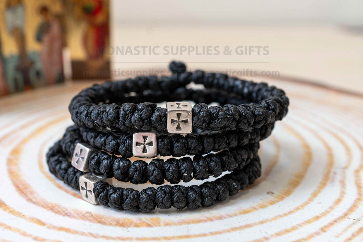 Thick black komboskini wristband with 33 knots and antique silver cross bead made in Greece