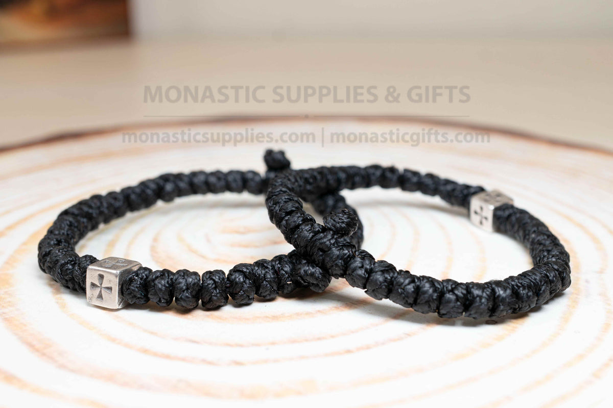 Thick black komboskini wristband with 33 knots and antique silver cross bead made in Greece