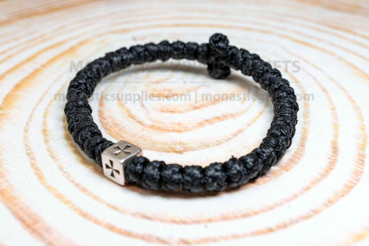 Thick black komboskini wristband with 33 knots and antique silver cross bead made in Greece
