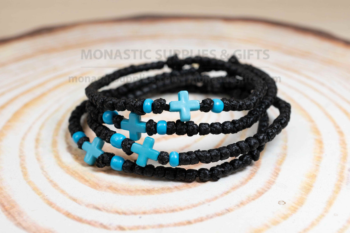 Black komboskini wristband with 33 knots and turquoise blue cross bead made in Greece