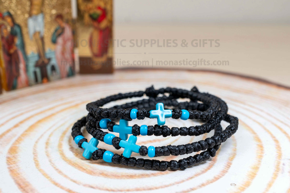 Black komboskini wristband with 33 knots and turquoise blue cross bead made in Greece