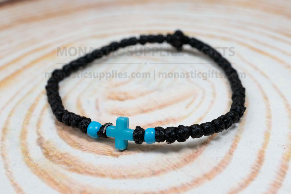 Black komboskini wristband with 33 knots and turquoise blue cross bead made in Greece