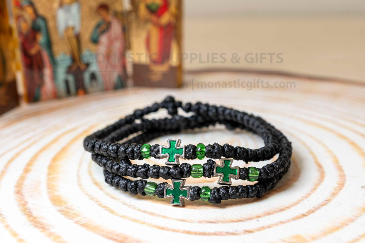 Prayer rope komboskini bracelet with green enamel cross and black knots made in Greece[cite: 6]