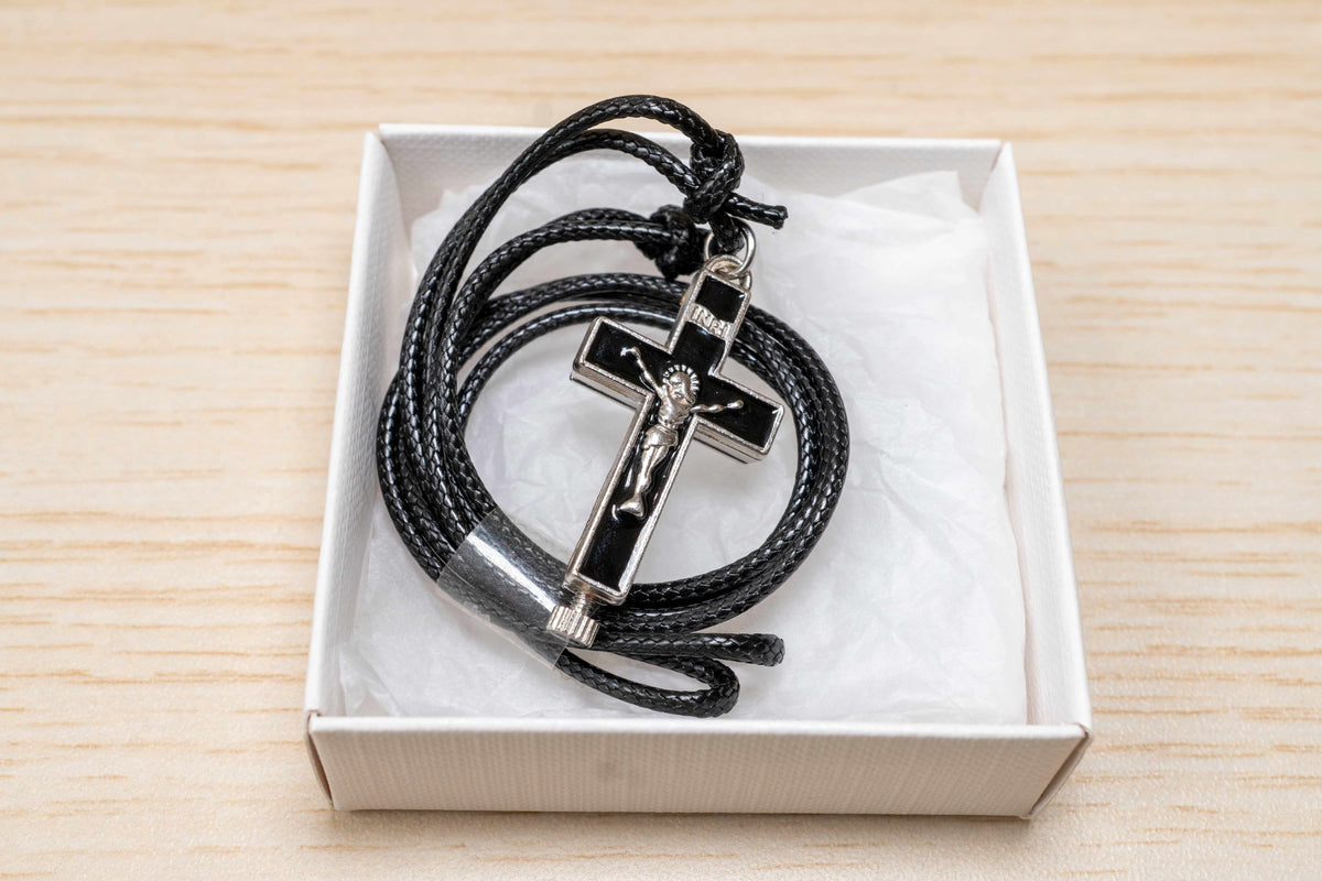 Opening metal reliquary cross pendant with enamel in black blue and red on adjustable genuine leather cord