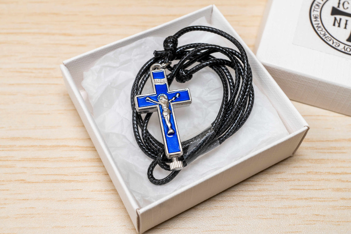 Opening metal reliquary cross pendant with enamel in black blue and red on adjustable genuine leather cord