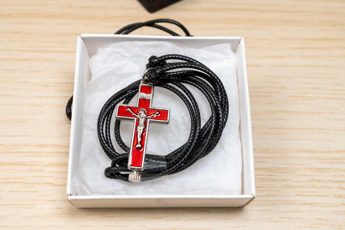 Opening metal reliquary cross pendant with enamel in black blue and red on adjustable genuine leather cord