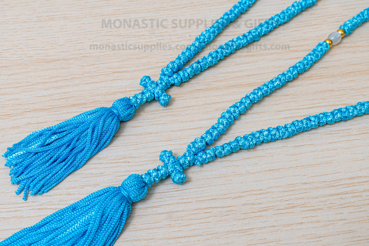 Light blue 100 knots prayer rope komboskini with white divider beads and knotted cross made in Greece