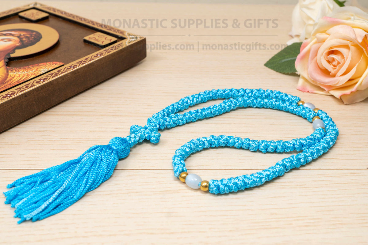 Light blue 100 knots prayer rope komboskini with white divider beads and knotted cross made in Greece